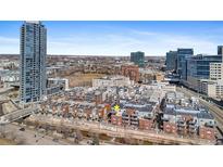 An aerial view showcases the complex, high rise office buildings and the water source in the foreground at 1438 Little Raven St # 407, Denver, CO 80202