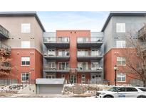 Stylish condominium featuring multiple balconies and a brick facade, conveniently located near city amenities at 1438 Little Raven St # 407, Denver, CO 80202