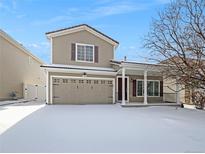 Two-story house with a snow-covered front yard and attached garage at 18986 E 51St Pl, Denver, CO 80249