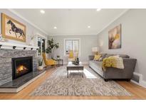 Bright living room with fireplace and hardwood floors at 1325 Clermont St, Denver, CO 80220