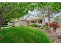 Charming home with manicured lawn and stone accents, showcasing curb appeal at 10877 W 55Th Ln, Arvada, CO 80002