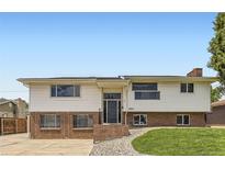 Charming two-story home with brick accents, landscaped front yard, and inviting front door at 8925 Oakwood St, Westminster, CO 80031