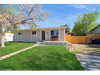 Charming single-story home with well-maintained lawn and inviting front porch area at 2080 E 84Th Ave, Denver, CO 80229