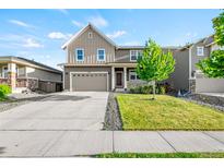 Charming two-story home with a well-manicured lawn and a two-car garage, curb appeal at 3074 Kestrel St, Brighton, CO 80601