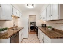 Well-lit kitchen showcasing modern appliances, granite countertops, and ample cabinet space at 7995 E Mississippi Ave # A20, Denver, CO 80247