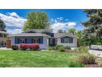 Charming single-Gathering home with light brick, lush landscaping, and mature trees under a partly cloudy blue sky at 5071 S Boston St, Greenwood Village, CO 80111