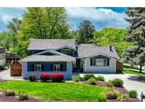 Charming single-Gathering home featuring mature trees and a well-manicured lawn with flower beds at 5071 S Boston St, Greenwood Village, CO 80111