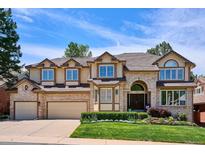Charming two-story home with lush lawn and a two car garage, providing curb appeal at 5331 S Geneva Way, Englewood, CO 80111