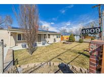 Ranch home featuring solar panels and low maintenance yard with a fire pit at 4909 W Mississippi Ave, Denver, CO 80219