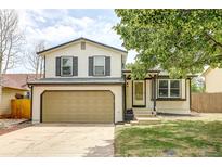 Charming two-story home featuring an attached garage and a well-manicured front lawn at 1488 S Biscay Ct, Aurora, CO 80017