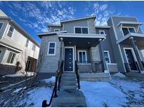 Modern two-story home with gray siding and stone accents, steps leading to the front entrance at 22841 E Stanford Ln # B, Aurora, CO 80015