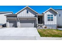 Charming two-story home with a two-car garage, well-manicured lawn, and beautiful curb appeal at 5925 La Posada Pl, Parker, CO 80134