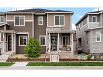 Charming home featuring stone accents, a cozy porch, and a manicured front yard at 5347 Warrior St, Frederick, CO 80504