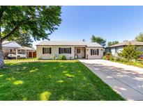 Charming single-story home with a well-manicured lawn and inviting curb appeal at 1748 W Tennessee Ave, Denver, CO 80223