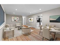 Bright living room with hardwood floors, neutral paint, and lots of natural light at 8305 Eaton Way, Arvada, CO 80003