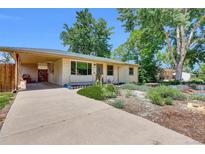 Charming single-story home with a covered parking and well-kept landscaping at 1225 S Honey Way, Denver, CO 80224