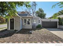 Charming single-story home featuring a well-maintained front yard and attached garage at 5138 W 46Th Ave, Denver, CO 80212