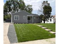 Charming single-story home with a well-maintained lawn and stylish gray siding at 1405 S Utica St, Denver, CO 80219