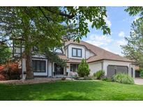 Charming two-story home boasts lush landscaping and a welcoming facade, creating instant curb appeal at 5955 Blue Sage Way, Littleton, CO 80123