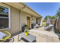 Charming front yard with stylish outdoor seating, decorative plants, and a brick facade at 2841 N Columbine St, Denver, CO 80205