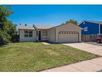 Charming single-story home with a well-manicured lawn and attached two car garage at 1718 S Flanders Way, Aurora, CO 80017
