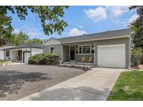 Charming single-story home featuring a well-maintained front yard, attached garage, and welcoming curb appeal at 1920 Elmira St, Aurora, CO 80010