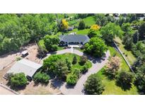 Expansive property with mature trees and well-maintained landscaping on a sprawling lot at 5700 S University Blvd, Greenwood Village, CO 80121