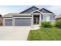 Charming single-Gathering home featuring a 3-car garage and a beautifully landscaped front yard at 577 Tristan Pl, Berthoud, CO 80513