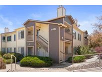 Inviting exterior showcasing the well-maintained facade of the two-story condo building in a desirable community at 8615 W Berry Ave # 203, Littleton, CO 80123