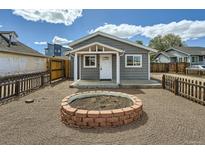 Charming home with a cozy front yard and a custom fire pit, perfect for outdoor entertaining at 1533 E Harlan, Lakewood, CO 80214