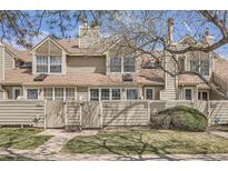 Charming townhouse exterior featuring well-kept lawns and a private fenced entrance at 7373 E Iowa Ave # 1112, Denver, CO 80231