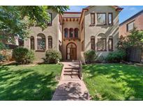 Charming home featuring a manicured lawn, quaint front entry, and warm curb appeal at 1640 N Downing St # 103, Denver, CO 80218