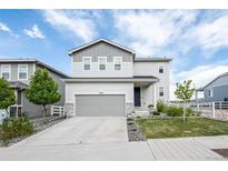 Charming two-story home with a well-maintained lawn, a two car garage, and neutral color palette at 3699 Makley Cir, Castle Rock, CO 80104