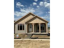 New home featuring a charming front porch with stone pillars and a combination of lap siding and shake at 30 Waterford St, Erie, CO 80516