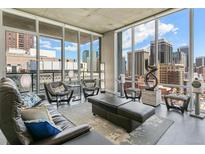 Bright and airy living room featuring expansive windows with stunning city views and sleek modern decor at 891 14Th St # 1408, Denver, CO 80202