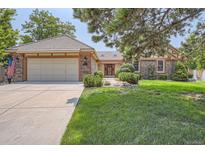 Brick ranch home with attached garage and landscaped lawn at 8272 Bighorn Ct, Lone Tree, CO 80124