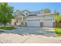 Charming two-story home with a three-car garage, covered porch, and well-maintained landscaping at 4844 Mt Evans St, Brighton, CO 80601