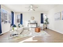 Bright living room with modern furnishings, hardwood floors, and a ceiling fan at 4844 Mt Evans St, Brighton, CO 80601