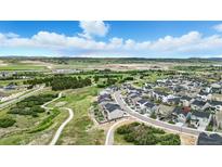 Beautiful aerial view of the community with a walking trail surrounded by greenery and mountains in the background at 624 Simmental Loop, Castle Rock, CO 80104