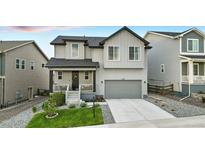 Charming two-story home boasts a well-manicured lawn, a two-car garage, and a welcoming front porch at 624 Simmental Loop, Castle Rock, CO 80104