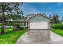 Charming home with a two-car garage, stone accents, and lush landscaping for great curb appeal at 123 Wheat Ridge St, Palmer Lake, CO 80133