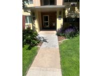 Inviting entrance to the building with a well-maintained walkway and lovely landscaping at 665 S Clinton St # 14A, Denver, CO 80247