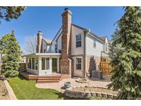 Charming home featuring a beautiful backyard, large patio, and a well-manicured lawn perfect for outdoor gatherings at 7559 S Ivanhoe Cir, Centennial, CO 80112