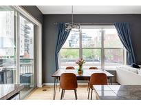 Bright dining area with modern chandelier, natural light, and urban views at 1440 Little Raven St # 202, Denver, CO 80202