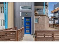 Contemporary home featuring a blue front door, metal siding and a modern design at 3142 W 20, Denver, CO 80211