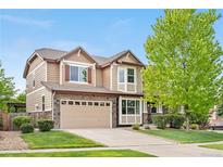 Charming two-story home with a manicured lawn, stone accents, and a two-car garage at 23870 E Dorado Pl, Aurora, CO 80016