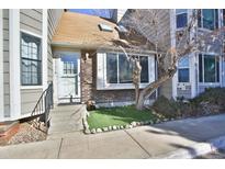 Charming townhome with brick facade, concrete steps, and drought-tolerant landscaping at 7978 Chase Cir # G, Arvada, CO 80003