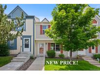 Charming townhome with well-manicured lawn and inviting entrance, showcasing its curb appeal at 9278 W Ontario Dr, Littleton, CO 80128