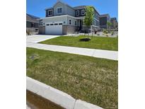 Charming two-story home with a two-car garage and a well-manicured lawn on a sunny day at 27986 E Frost Pl, Aurora, CO 80016