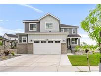 Beautiful two-story home featuring a gray and white exterior, attached two-car garage, and a well-manicured front lawn at 27986 E Frost Pl, Aurora, CO 80016